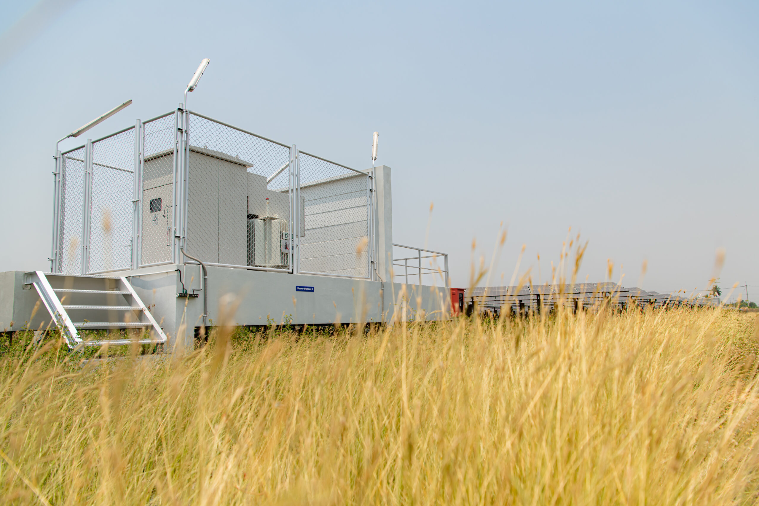 a white building in a field of tall grass